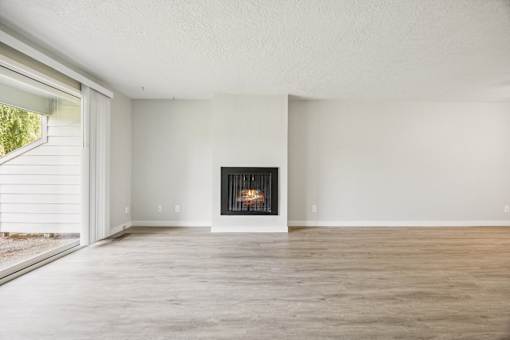A modern living room with a fireplace and a sliding glass door.