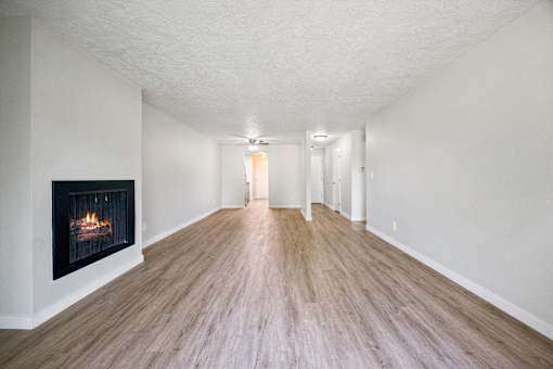 A long hallway with a fireplace on the left side.