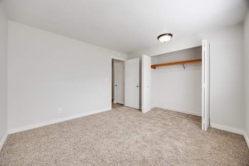 A room with a carpeted floor and white walls.