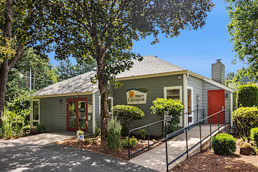 A building with a red door and a sign that says "Mount of Creekside".