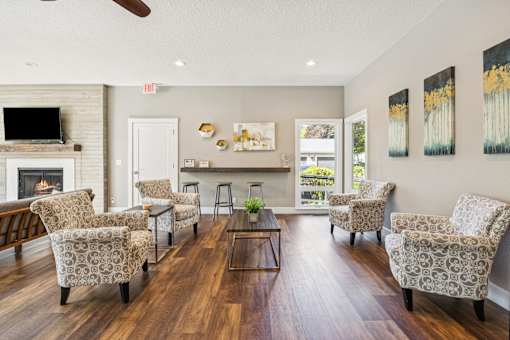 A living room with a fireplace and chairs.
