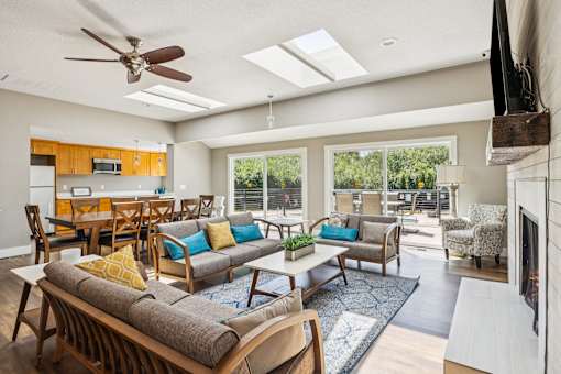 A living room with a grey couch and a wooden table.