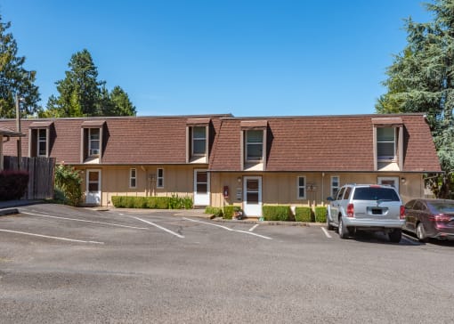a picture of the front of a building with a parking lot in front of it