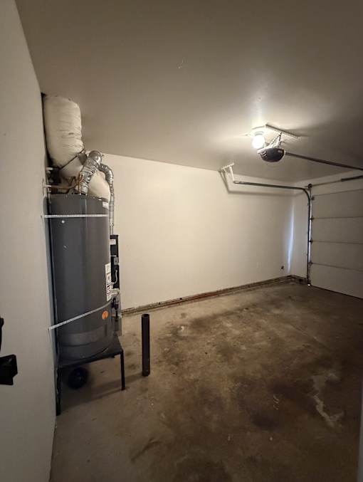 A room with a water heater and pipes.