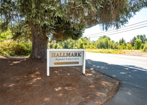 a sign in front of a tree