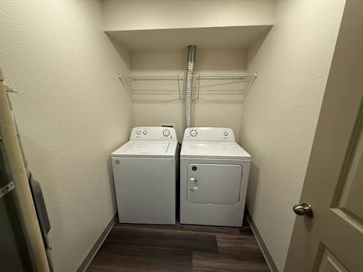 Two washing machines in a small laundry room.