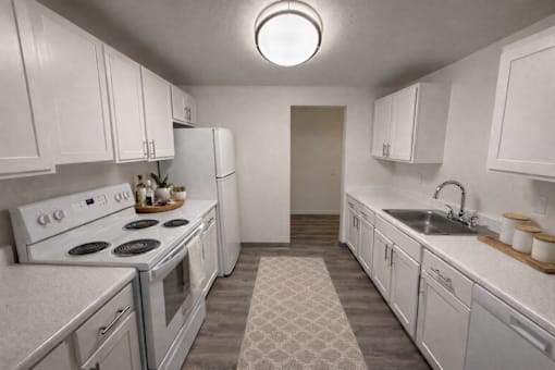 A kitchen with white appliances and cabinets.
