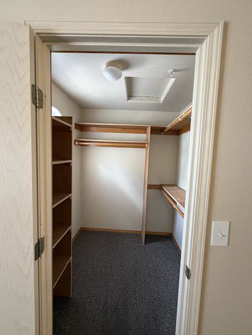A small room with a closet and a skylight.