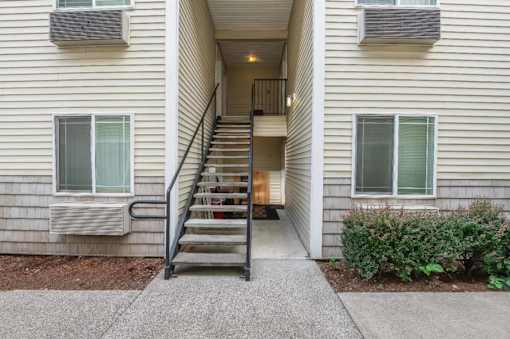 A staircase leads to a doorway in a building.