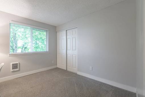A room with a window and a door.