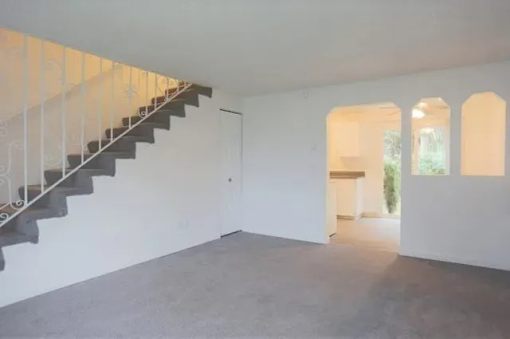 A room with a staircase and a window.