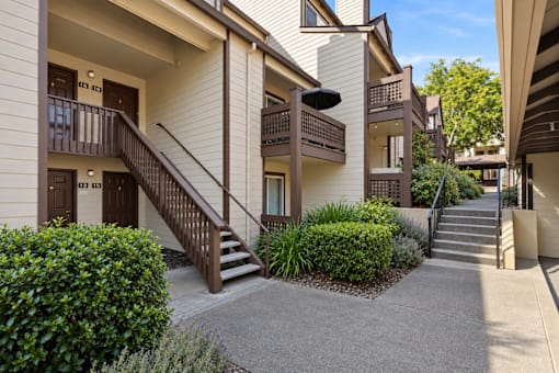 Apartment complex with a small garden in front.