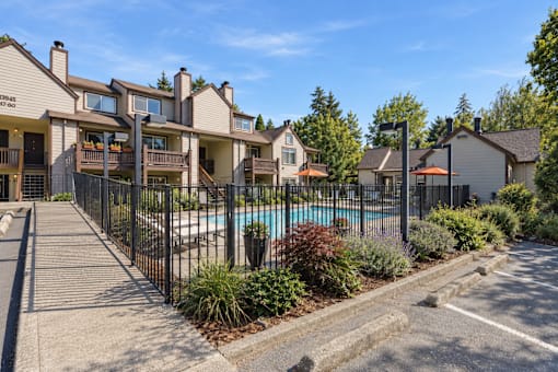 A row of houses with a pool in front.