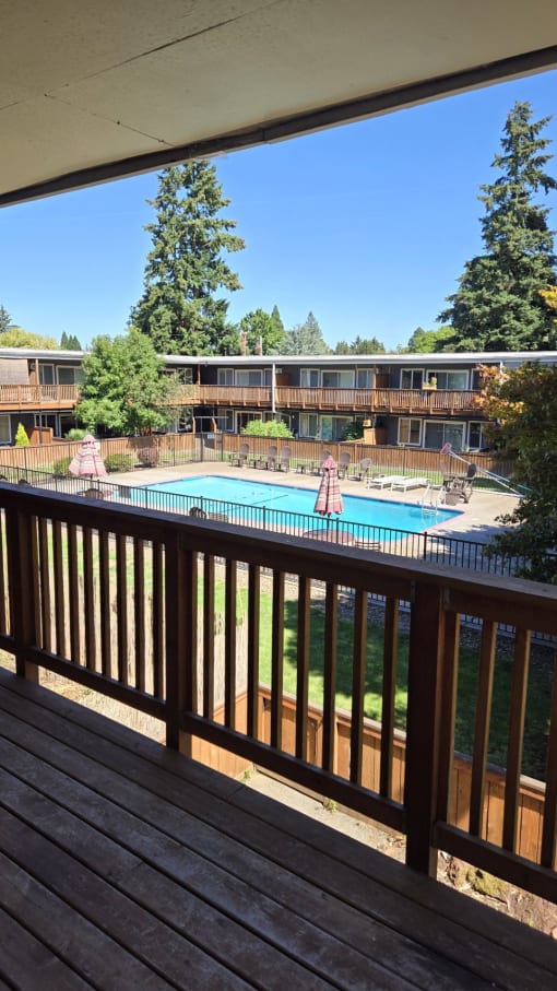 a view of the pool from the balcony of a resort