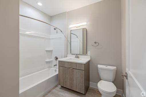 A bathroom with a toilet, sink, and bathtub.