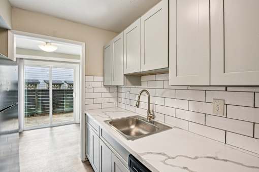 A kitchen with a sink and cabinets.