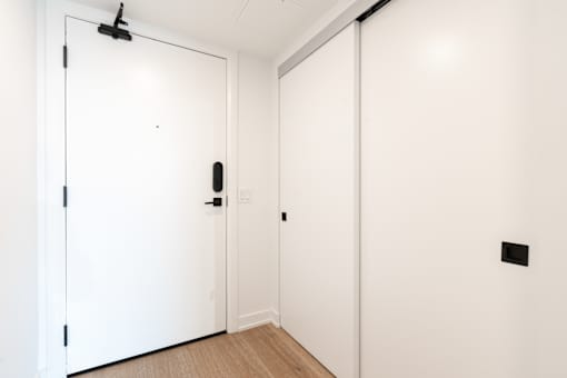A white door with a black handle and a black latch.
