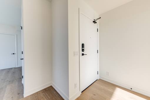 A white door with a black handle and a black lock.
