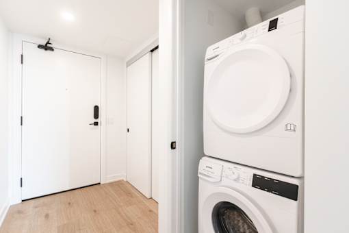 A white washing machine and dryer in a laundry room.