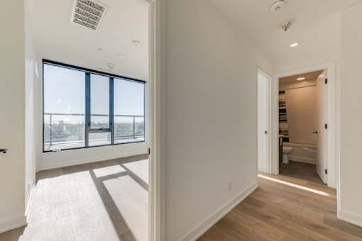 A white room with a window and a door.