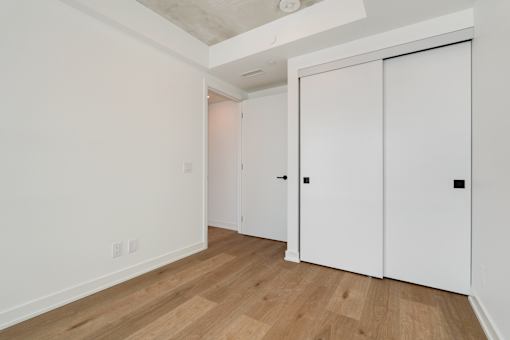 A room with a white door and a white wall.