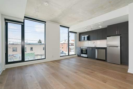 A kitchen with a refrigerator, oven, and microwave.