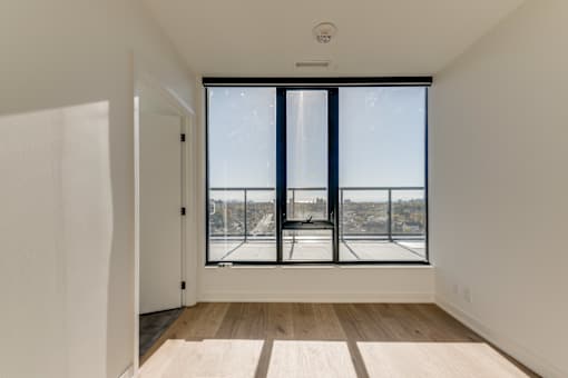 A room with a large window overlooking a snowy landscape.