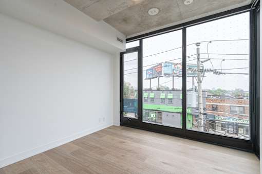 A room with a view of the city through large windows.