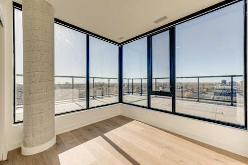 A room with a large window overlooking a cityscape.