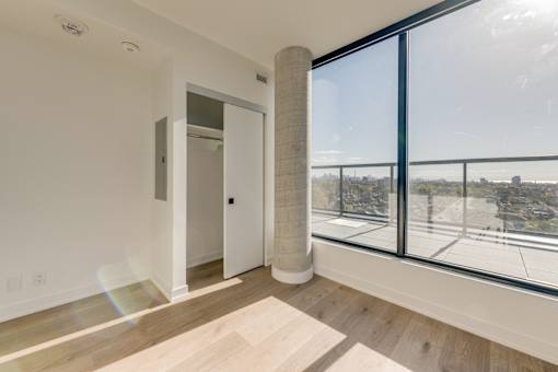 A room with a large window overlooking a cityscape.