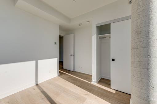 A room with white walls and a wooden floor.