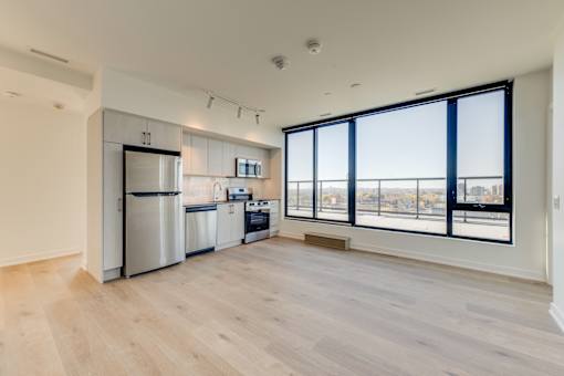 A kitchen with a refrigerator, dishwasher, and oven is shown in this image.