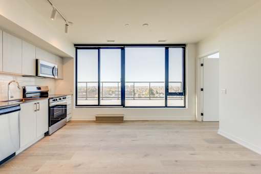 A kitchen with white cabinets and a microwave above the stove.