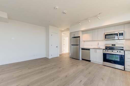 A kitchen with white cabinets and stainless steel appliances.