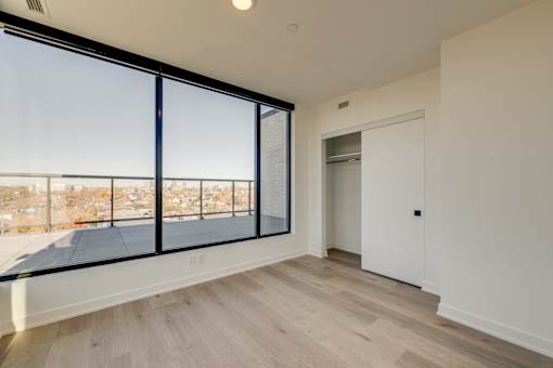 A room with a large window and a sliding door.