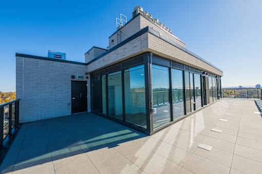 A modern building with a flat roof and large glass windows.