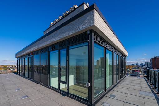 A modern building with a glass facade and a flat roof.