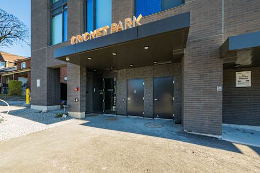 The Cricket Park building is made of brick and has a large entrance.