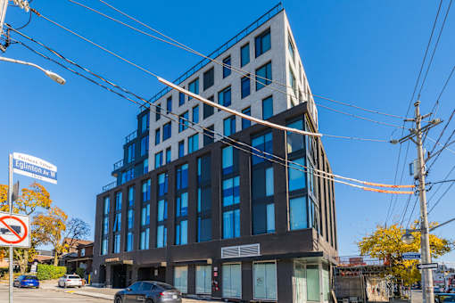 A modern building with a glass facade is located on Elgin Street.