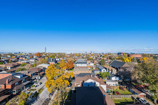 A view of a residential area with houses and trees.