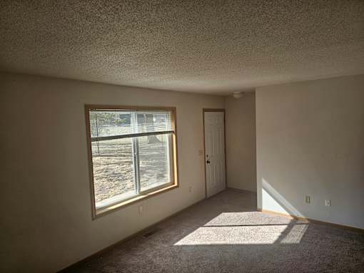 A room with a window and a door.