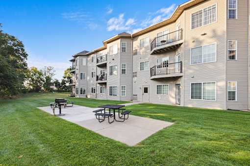 A sunny day at the apartment complex with a picnic table in the foreground.