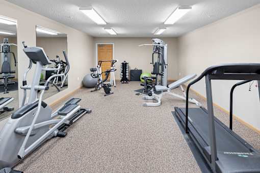 A well-equipped gym with treadmills, exercise bikes, and other fitness machines.