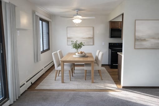 A dining room with a table set for four.