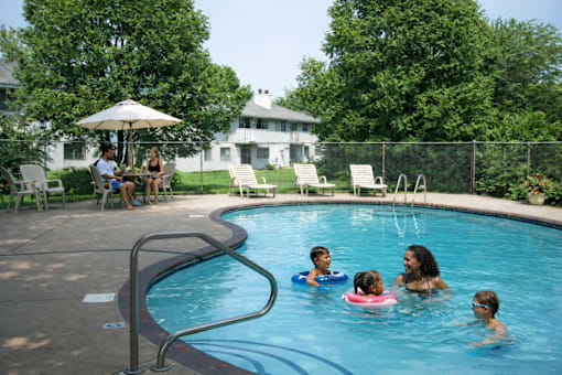 A group of people are enjoying a swim in a pool.