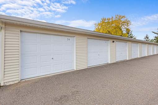 A row of white garage doors numbered from 21 to 24.