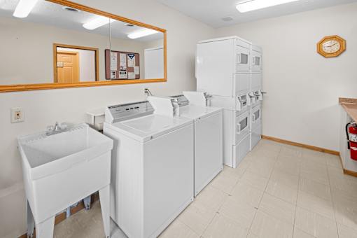 A white sink and a white cabinet are in a room.