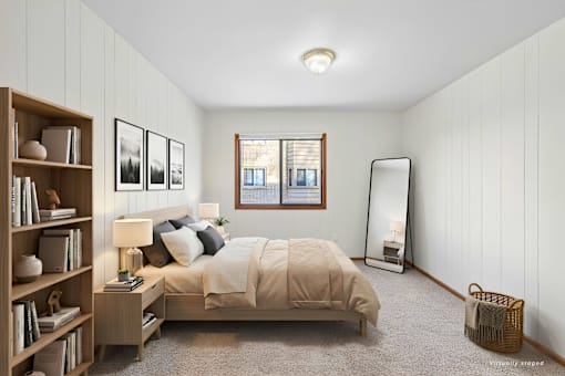A bedroom with a bed, nightstand, and a bookshelf.