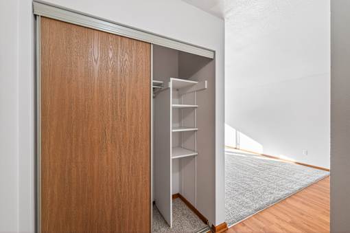 A brown door with a shelf underneath it.