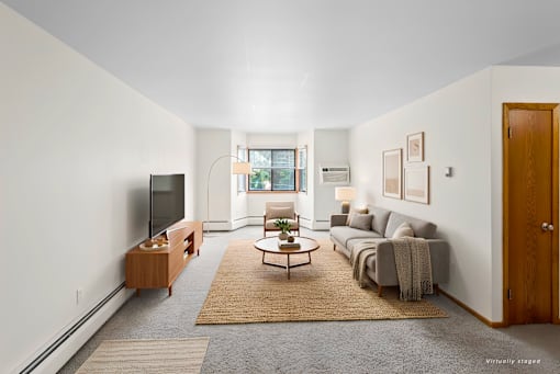 A living room with a grey couch and a wooden coffee table.